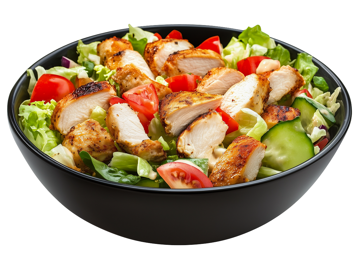 A bowl of salad containing chicken cubes, tomatoes, iceberg lettuce, and much more.