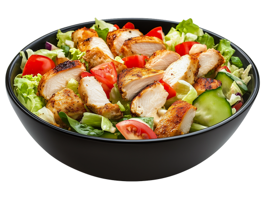 A bowl of salad containing chicken cubes, tomatoes, iceberg lettuce, and much more.