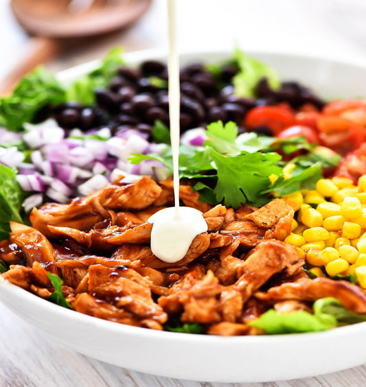 A bold salad bowl mixed with chicken cubes, corn, onions, tomatoes and dipped with mayo sauce