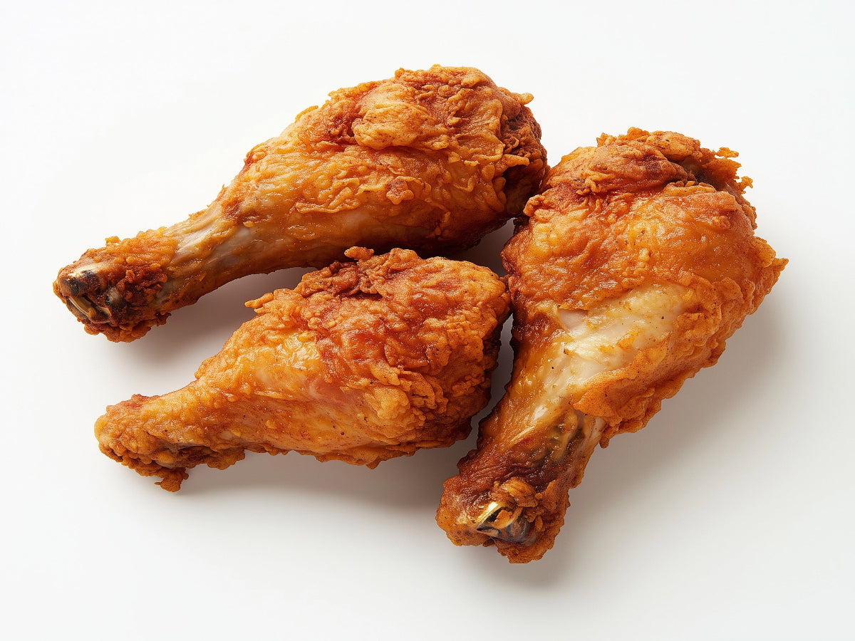 Chicken leg pieces on a white background with a crispy texture