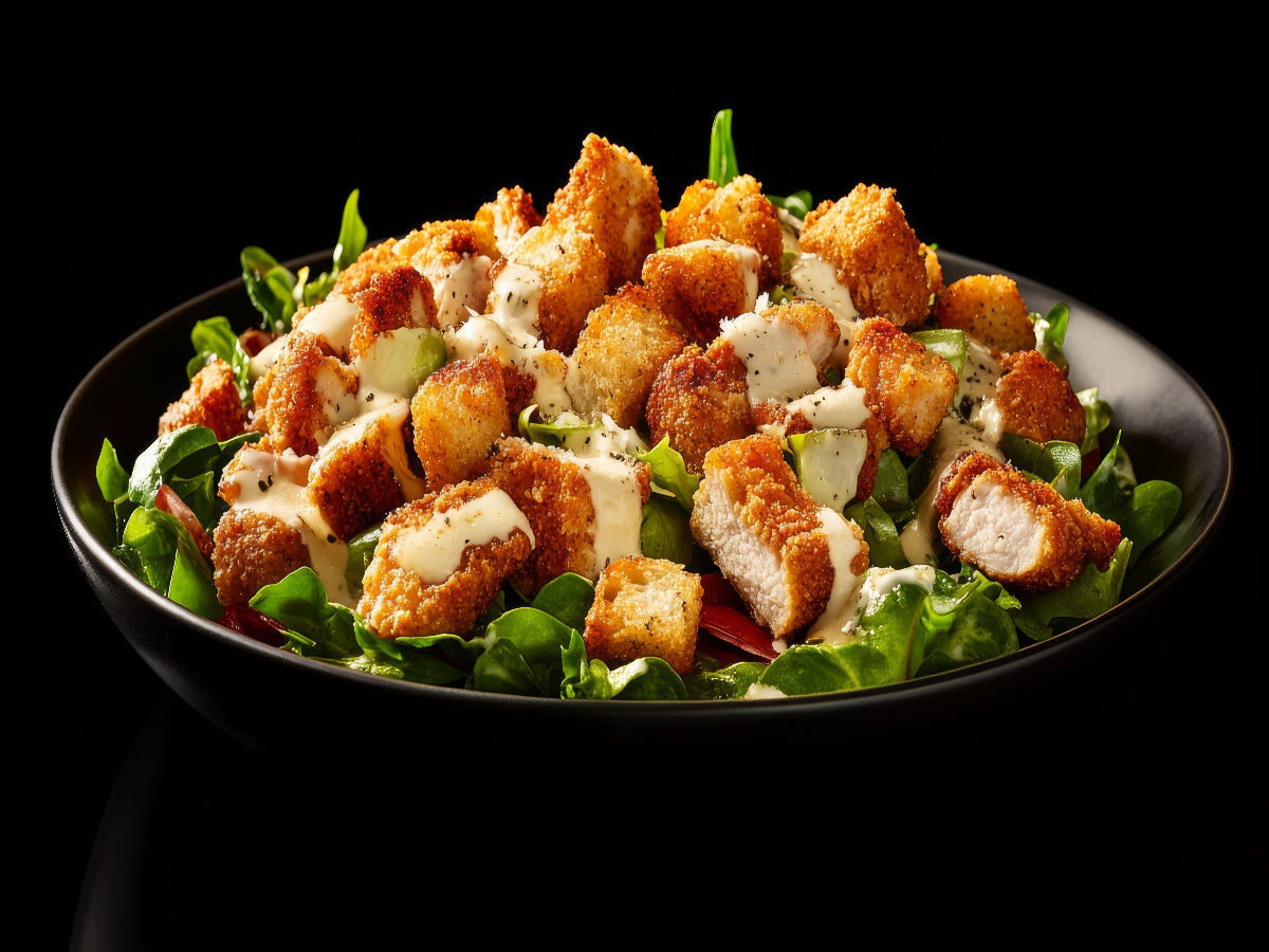 Crispy chicken salad bowl served in a black bowl
