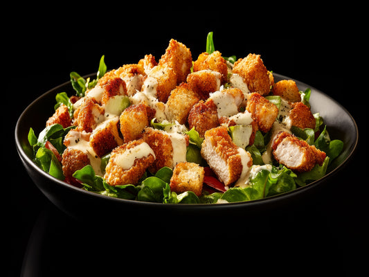 Crispy chicken salad bowl served in a black bowl