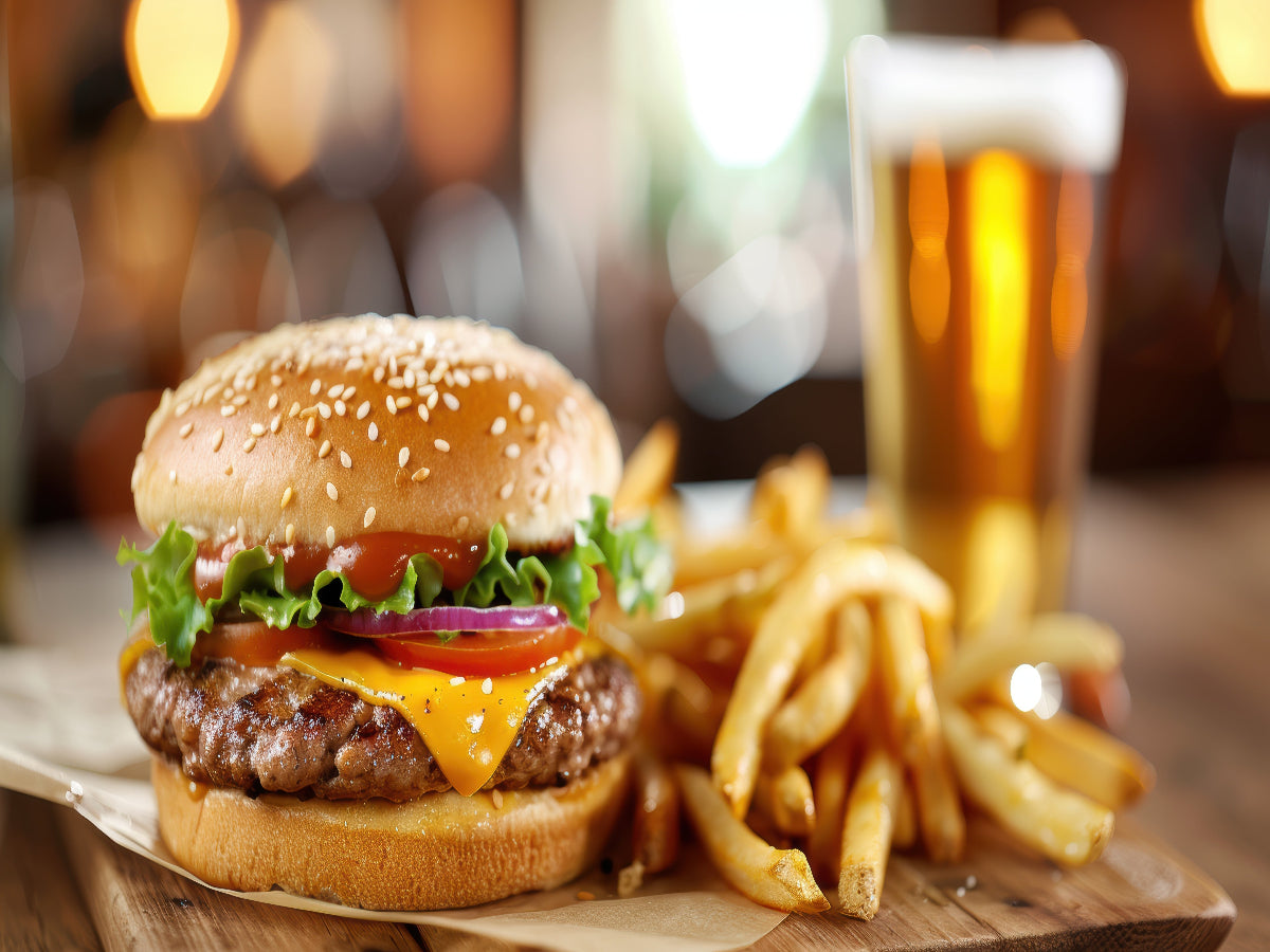 Juicy beef burger with melted cheese, fresh lettuce, and tomato, served on a toasted bun.