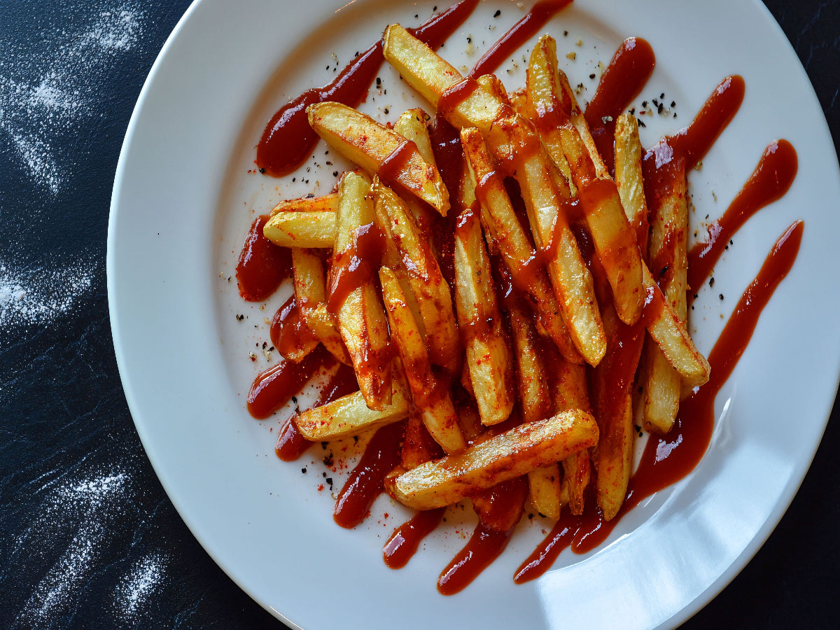 Golden crispy French fries served with ketchup.