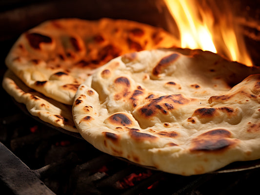 Freshly baked Tandoori Naan with crispy edges – food delivery Karachi