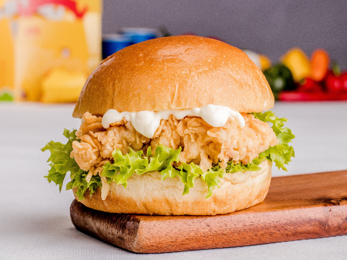 Zinger Burger with crispy spicy chicken fillet, fresh lettuce, and creamy mayo on a toasted bun.