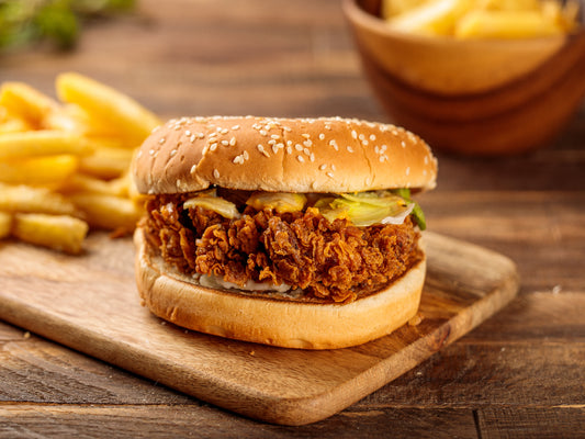 Close-up of Zinger Burger showing crispy chicken fillet and spicy batter with fresh lettuce.